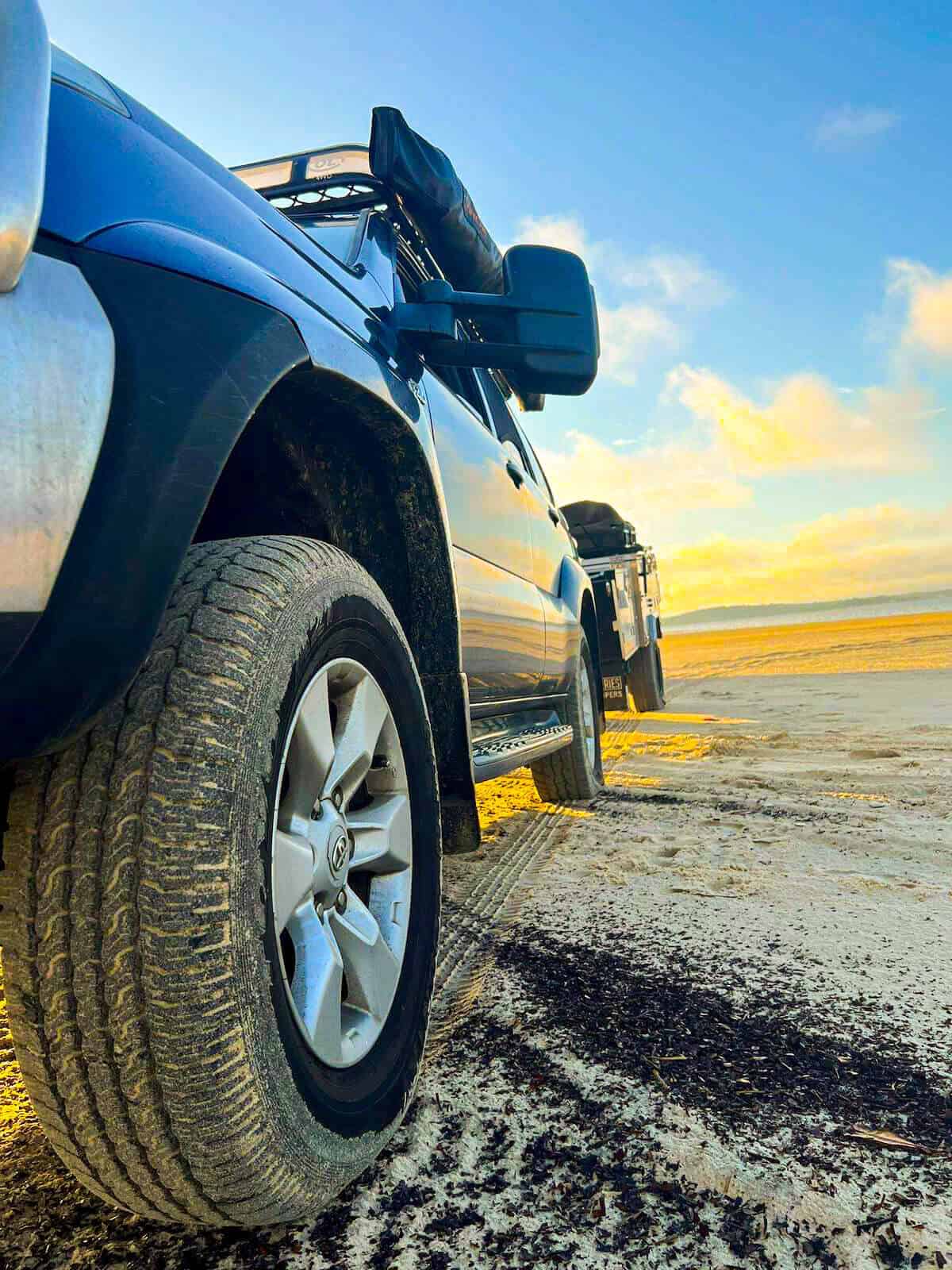 4wd car driving on sand on fraser island