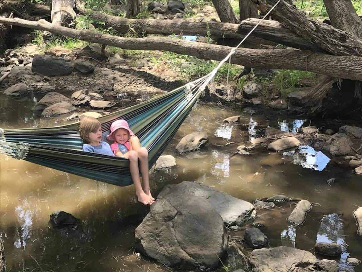 hammock over water with 2 kids at bestbrook camping ground