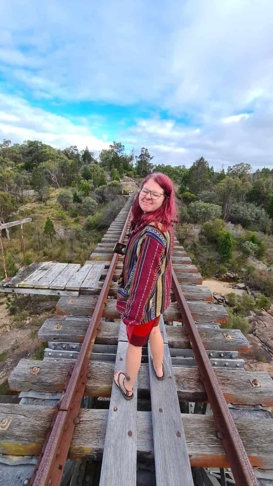 woman standing on rail track in stanthorpe