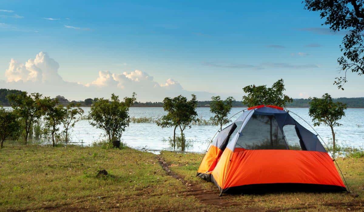 tent set up near a lakeside camping ground.