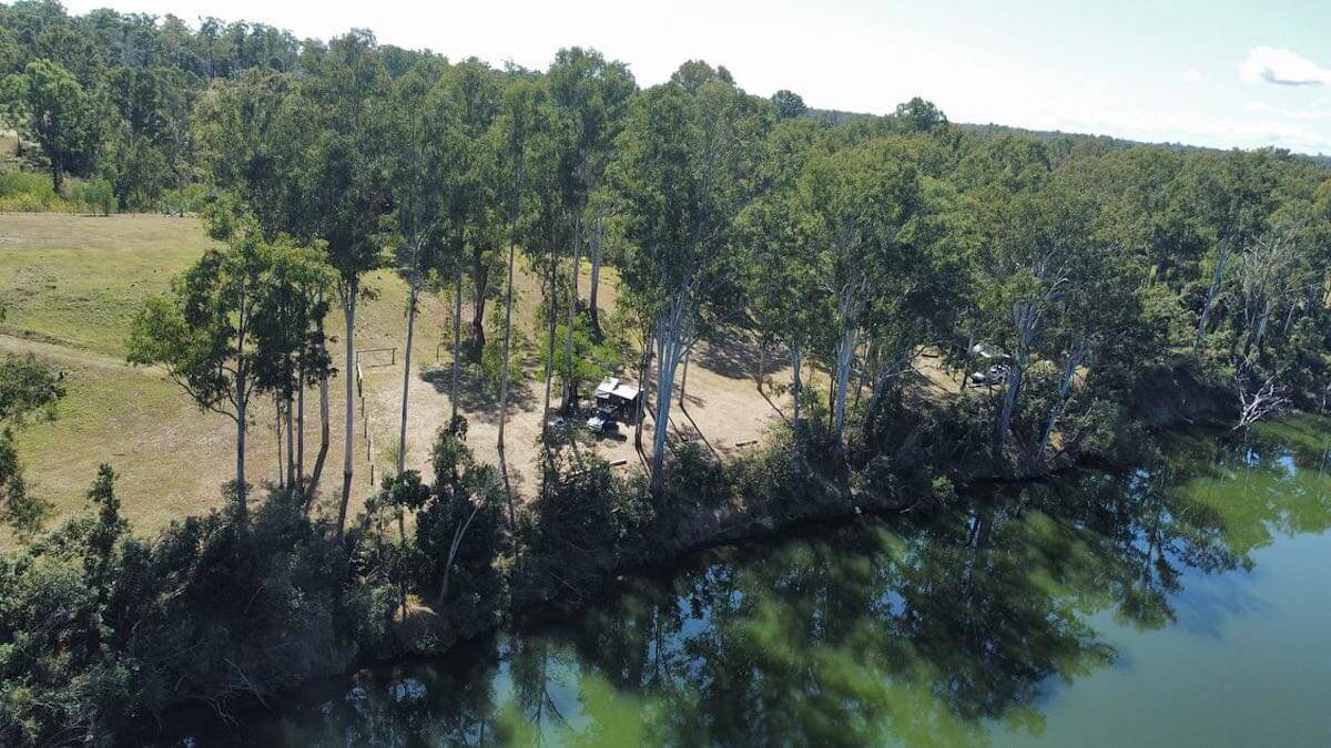 drone image of camper trailer and 4wd on edge of river in antigua queensland.